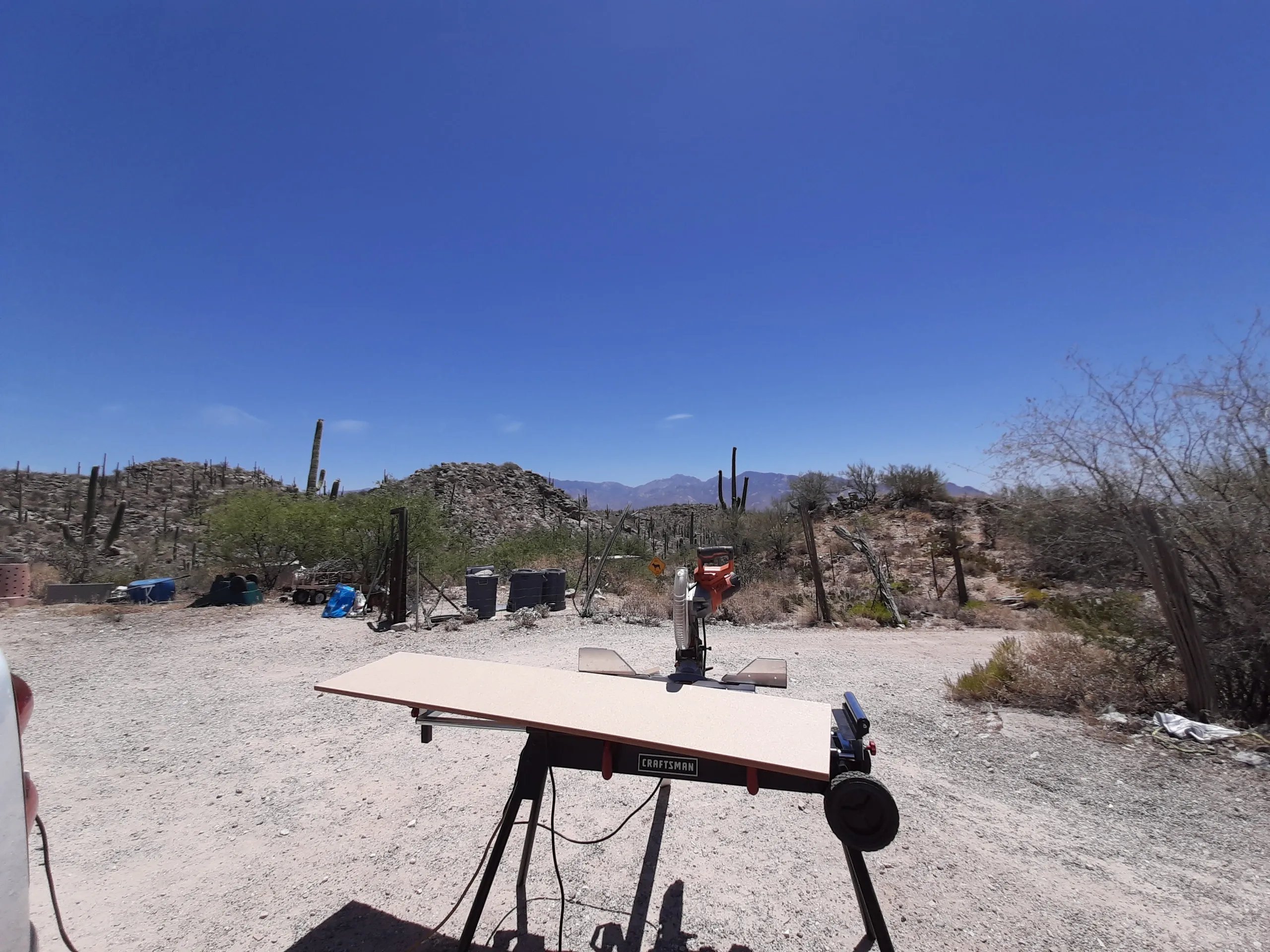 Craftsman workbench in desert landscape with cacti and mountains
